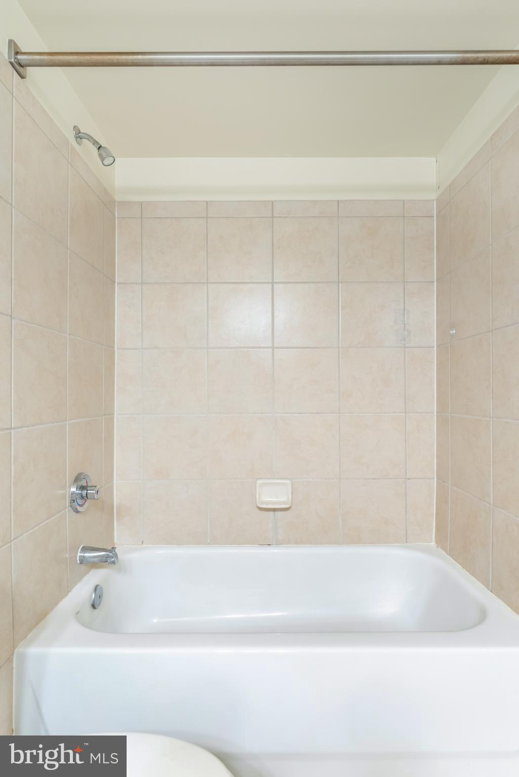 915 E Street Northwest, Unit 103 Washington, DC 20004 - Photo 13 of 43 a bathroom with a shower and a bathtub