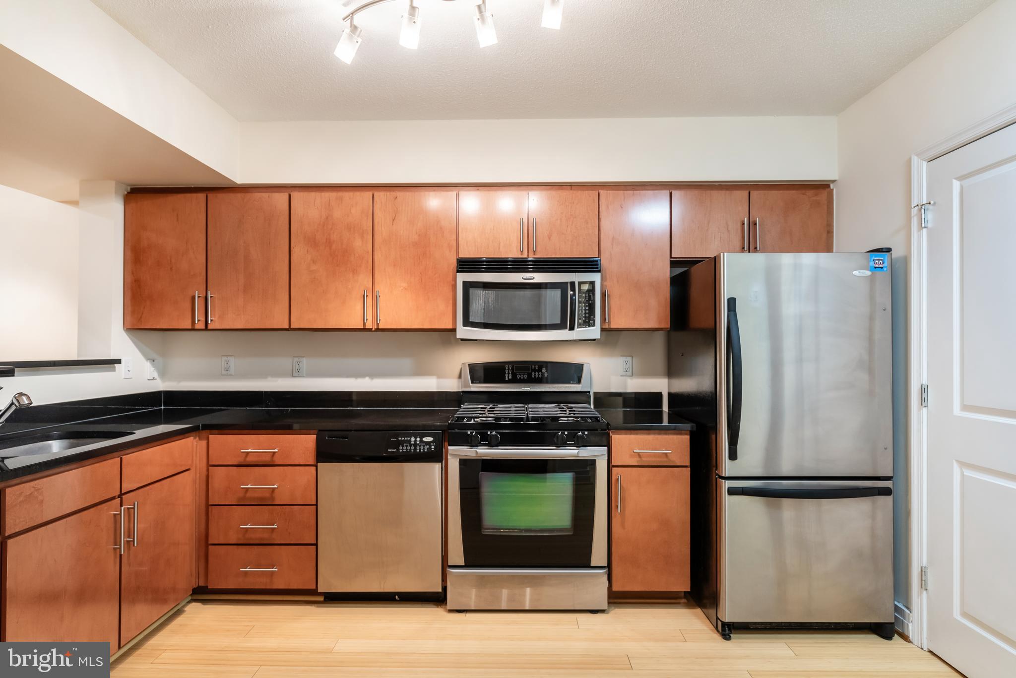 915 E Street Northwest, Unit 103 Washington, DC 20004 - Photo 18 of 43 a kitchen with a refrigerator stove and microwave