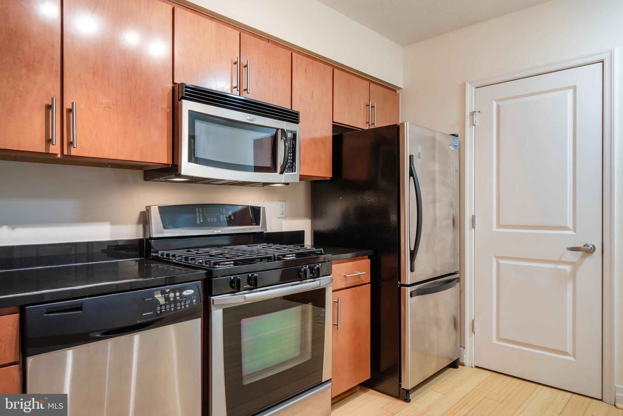 915 E Street Northwest, Unit 103 Washington, DC 20004 - Photo 19 of 43 a kitchen with stainless steel appliances a stove a microwave and a refrigerator
