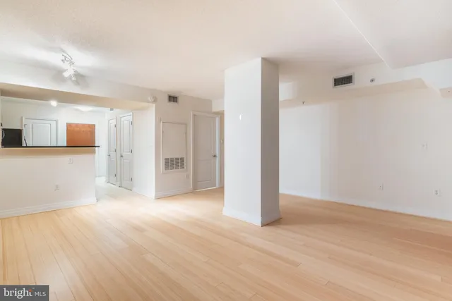 a view of a room with wooden floor