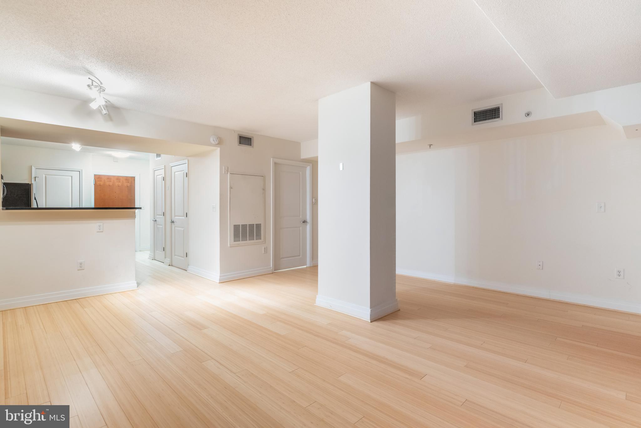 915 E Street Northwest, Unit 103 Washington, DC 20004 - Photo 22 of 43 a view of a big room with wooden floor and a window