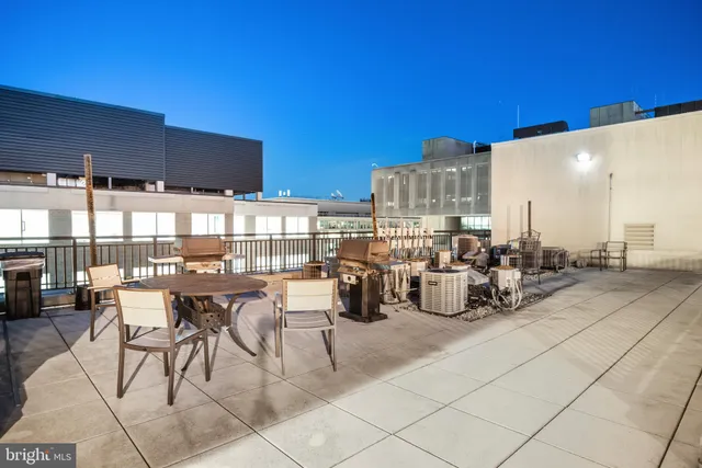 a large kitchen with stainless steel appliances kitchen island granite countertop a large island in the center