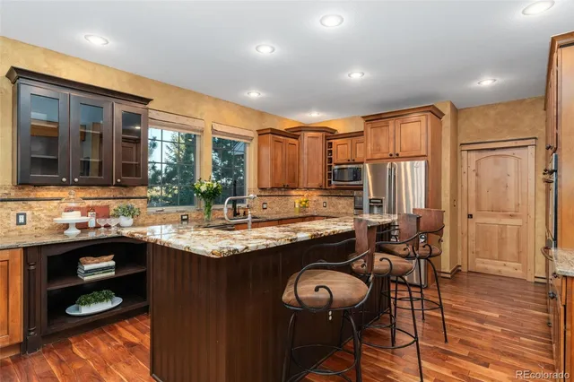 a kitchen with a stove sink and cabinets