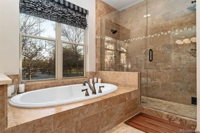 a bathroom with a bathtub a shower and a sink