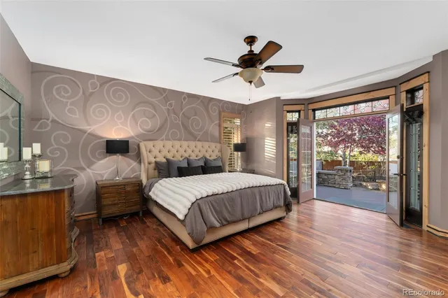 a bedroom with a large bed and a chandelier