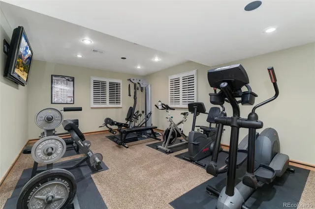 a room with furniture pool table and windows