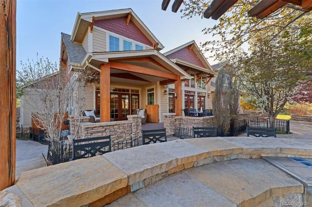 a view of backyard with table and chairs couches with wooden fence and plants