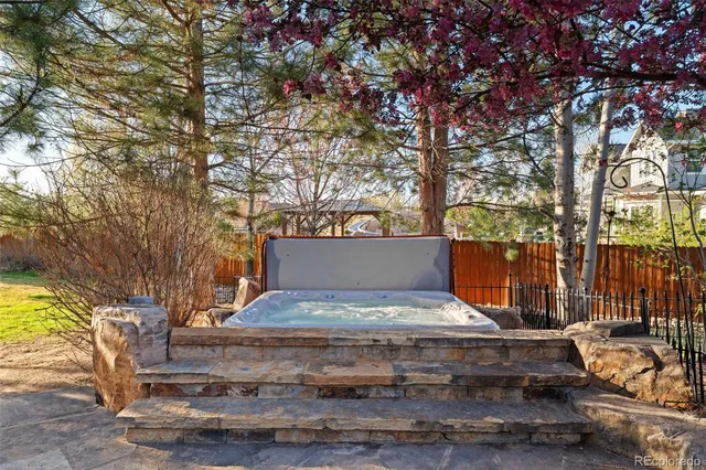 a living room with fireplace furniture and large windows