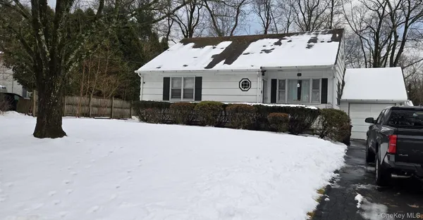 a aerial view of a house with a yard covered in snow