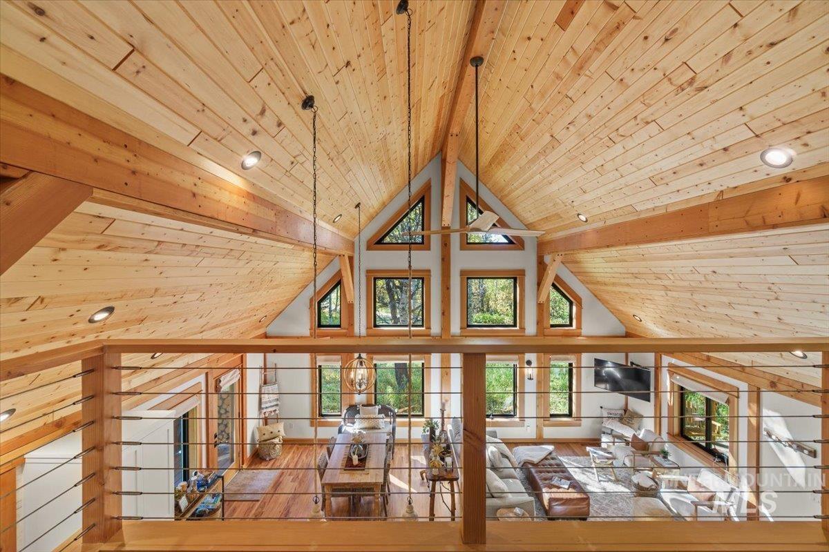 13982 Comfort Road McCall, ID 83638 - Photo 32 of 50 Unfurnished living room featuring a wood ceiling with exposed beams, hardwood / wood-style floors, and high vaulted ceiling