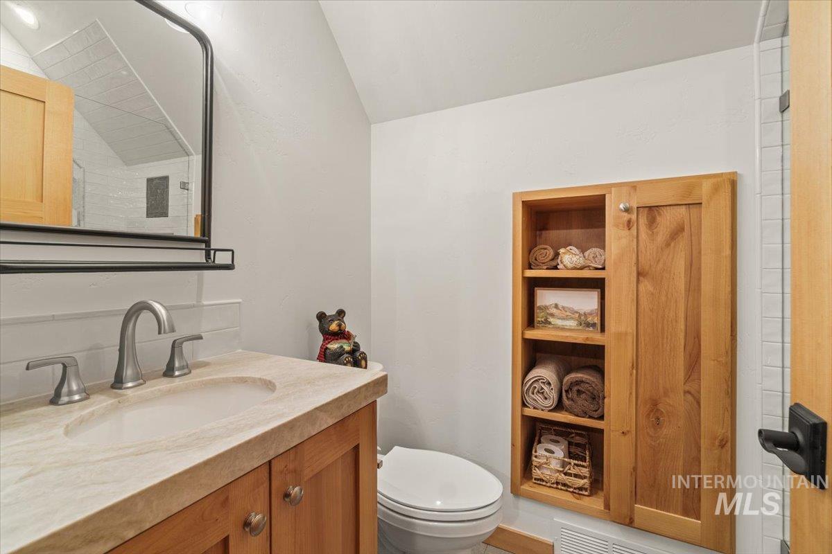 13982 Comfort Road McCall, ID 83638 - Photo 36 of 50 Half bath featuring vanity and lofted ceiling