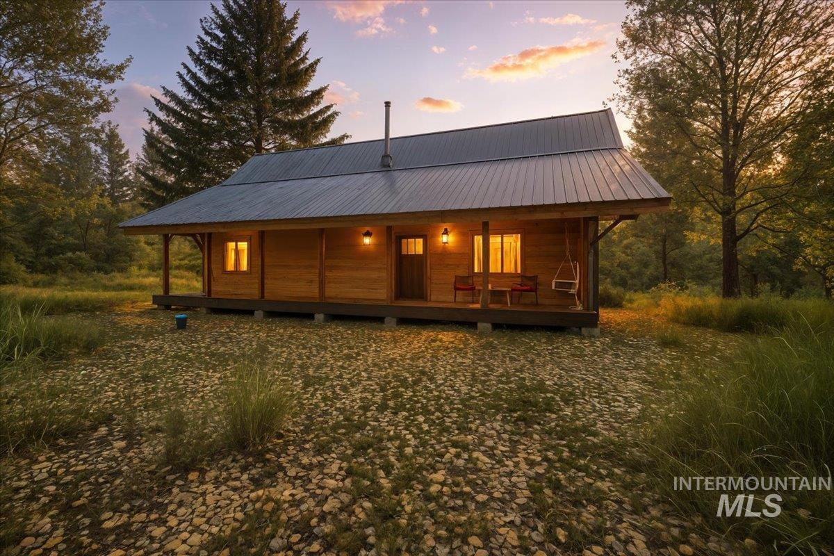 13982 Comfort Road McCall, ID 83638 - Photo 49 of 50 Back of property with a porch and a metal roof