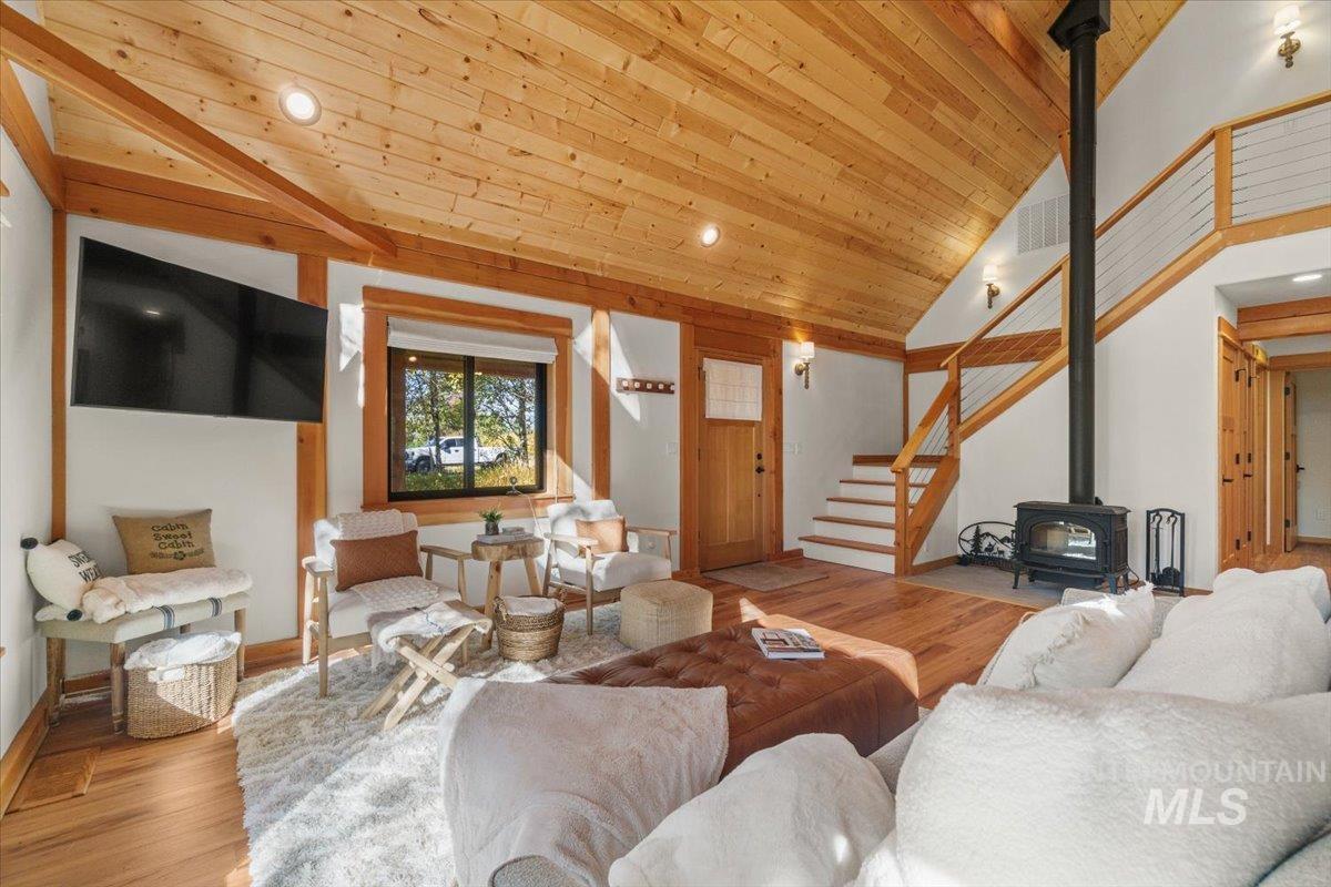13982 Comfort Road McCall, ID 83638 - Photo 9 of 50 Living room featuring wood finished floors, a wood stove, stairs, wooden ceiling, and recessed lighting