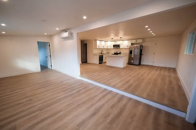 a view of a kitchen with a sink and a refrigerator