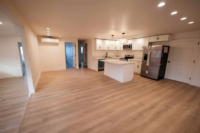 a view of a kitchen with a refrigerator and a window