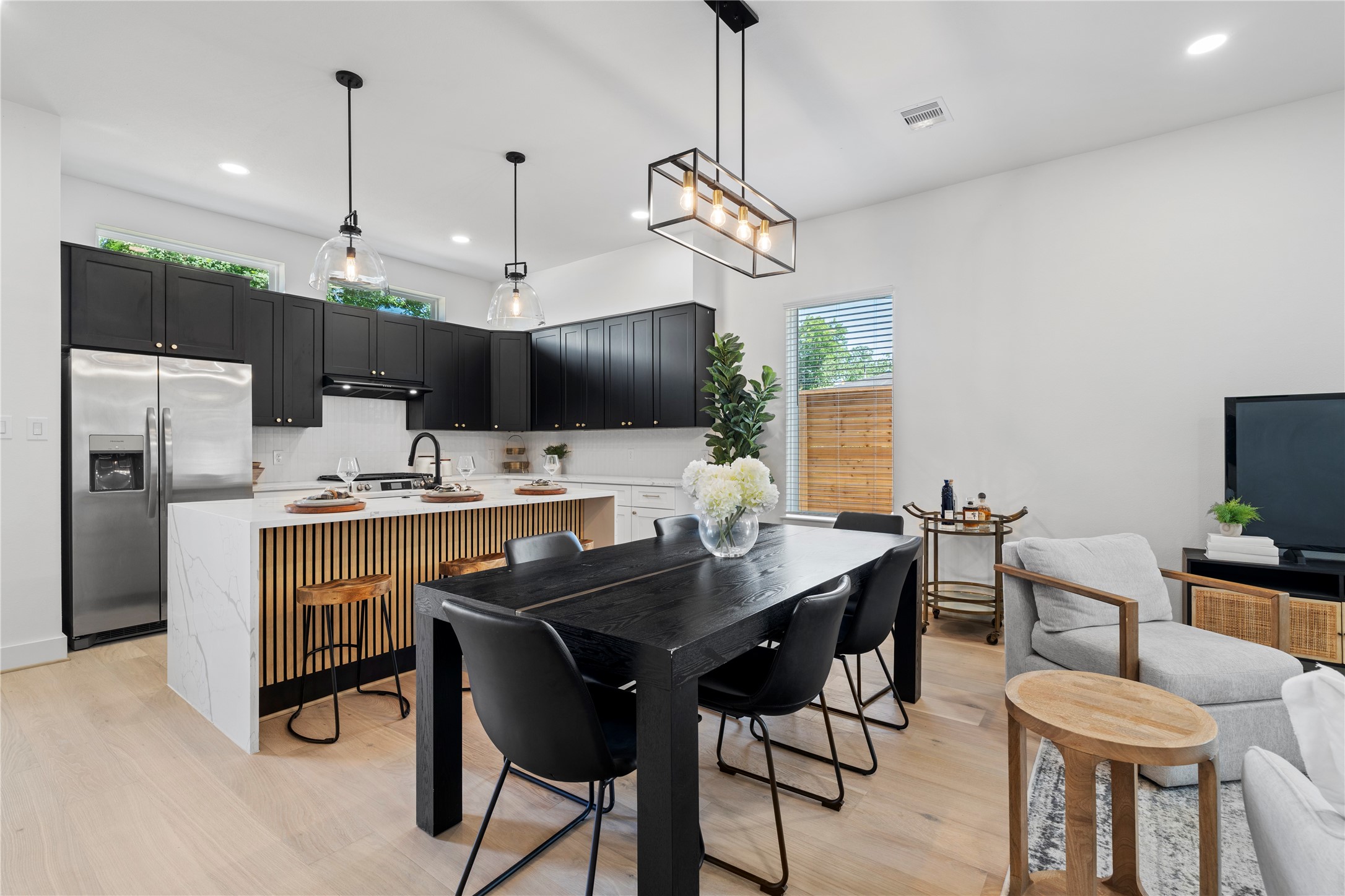 4108 Cortlandt Street Houston, TX 77022 - Photo 12 of 43 a kitchen with a dining table chairs sink and microwave