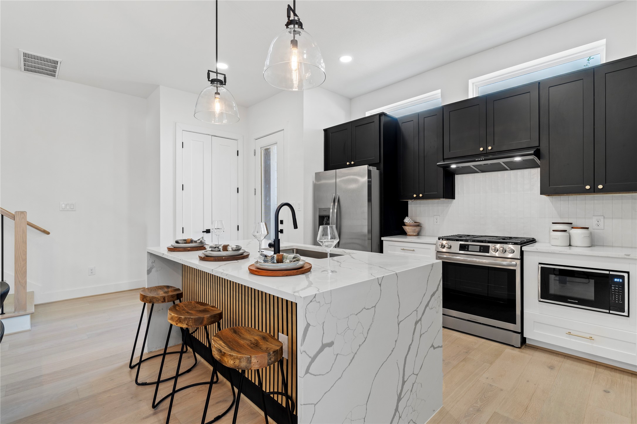 4108 Cortlandt Street Houston, TX 77022 - Photo 17 of 43 a kitchen with a stove a sink and a refrigerator