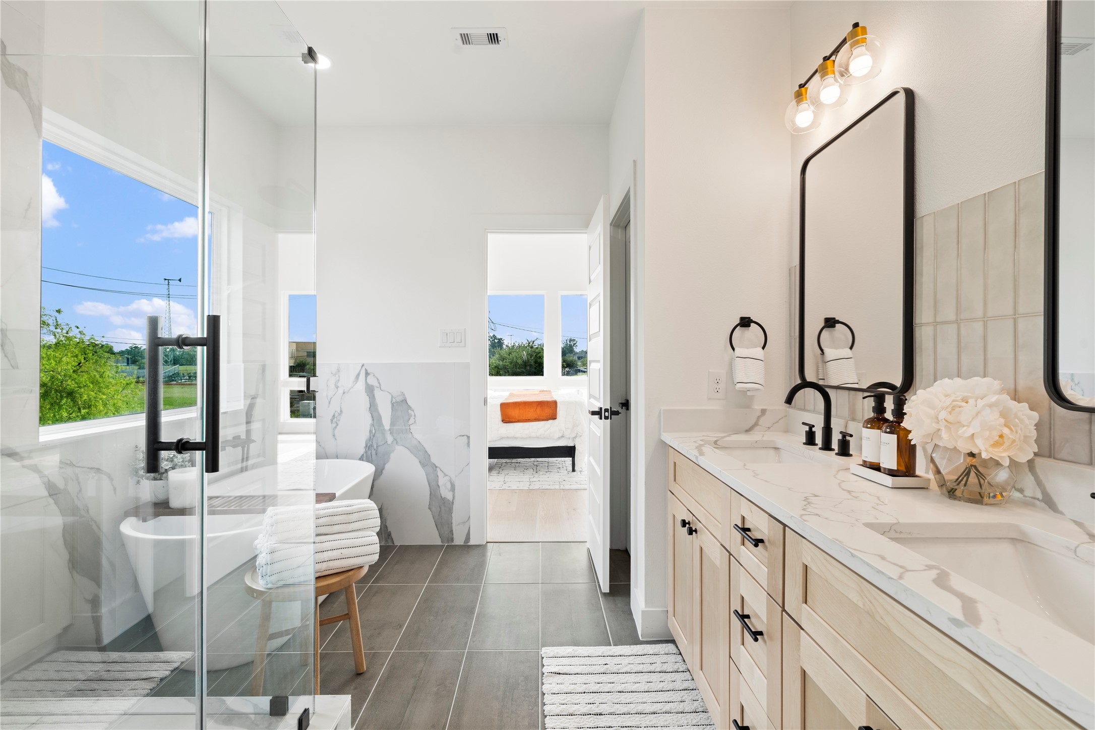 4108 Cortlandt Street Houston, TX 77022 - Photo 28 of 43 a spacious bathroom with a double vanity sink and a mirror