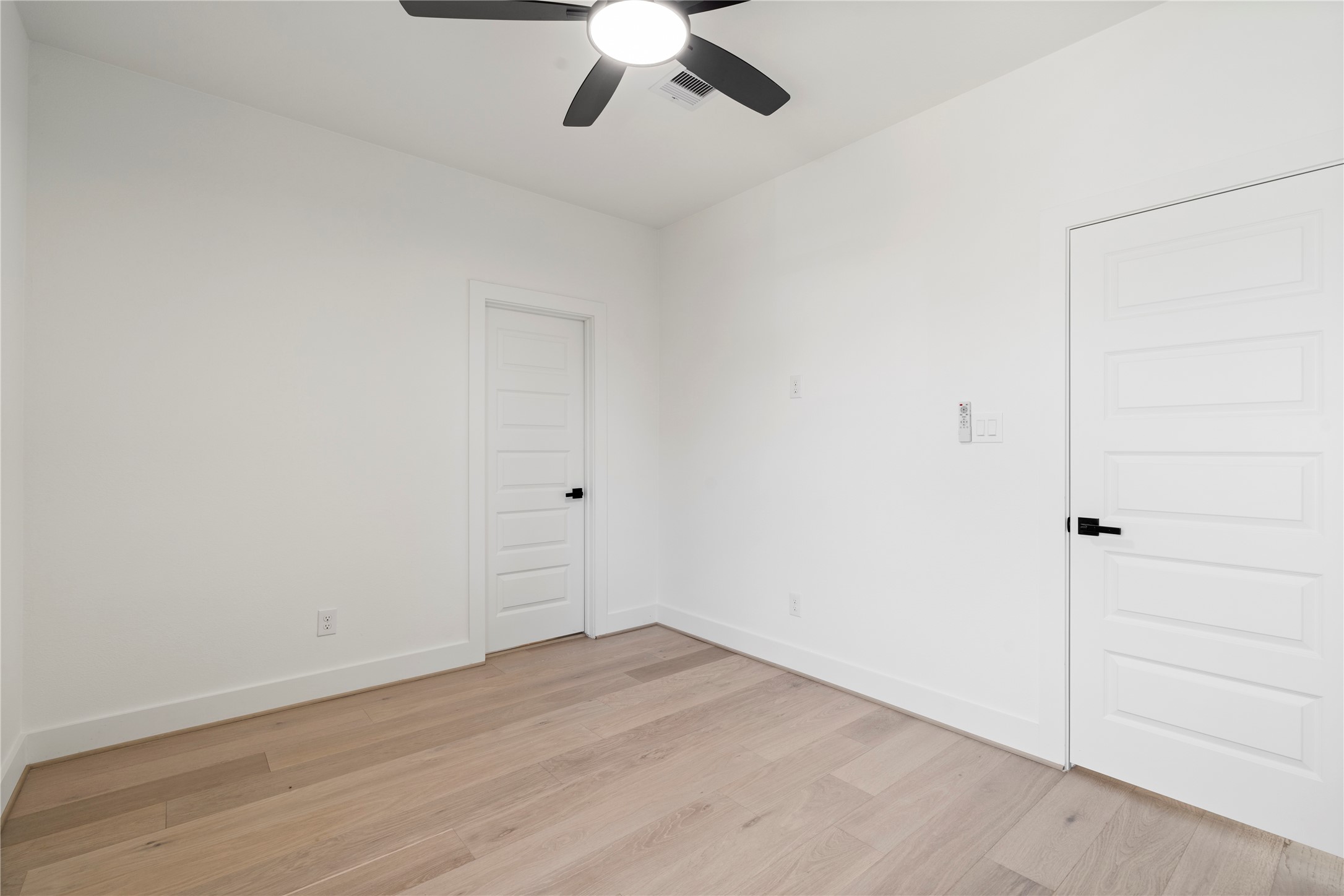 4108 Cortlandt Street Houston, TX 77022 - Photo 32 of 43 an empty room with a ceiling fan and wooden floor