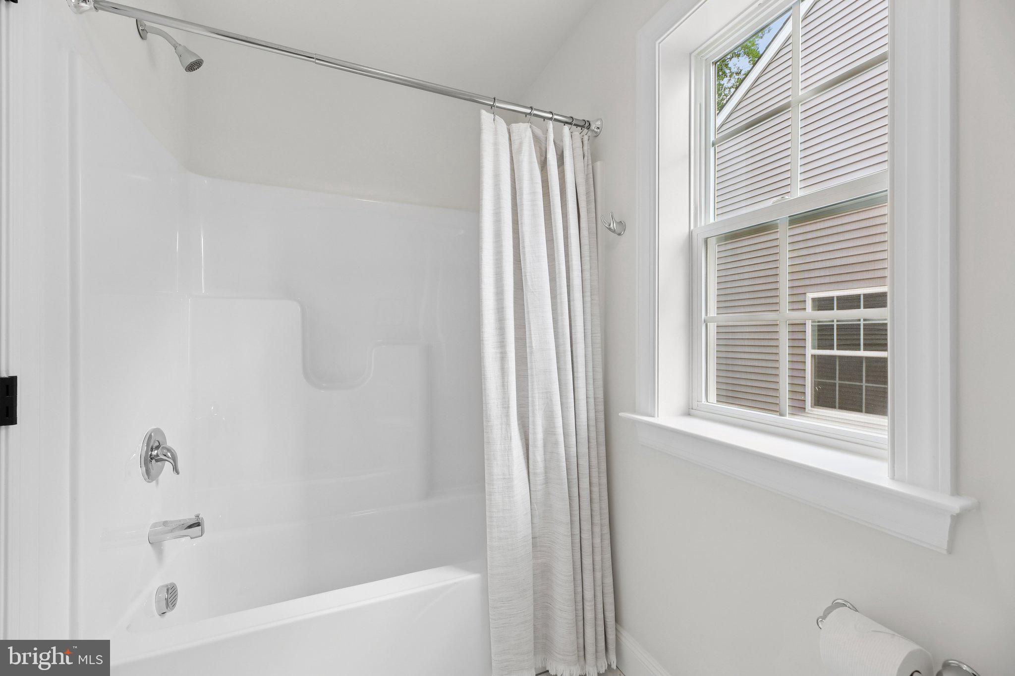 1823 Colt Lane Frederick, MD 21702 - Photo 40 of 66 a bathroom with a bathtub and a shower