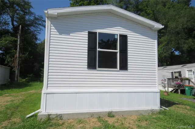 a view of house with backyard and garden