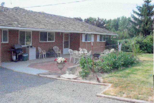 312 Warrior Road Yakima, WA 98901 - Photo 1 of 9 a backyard of a house with yard and outdoor seating