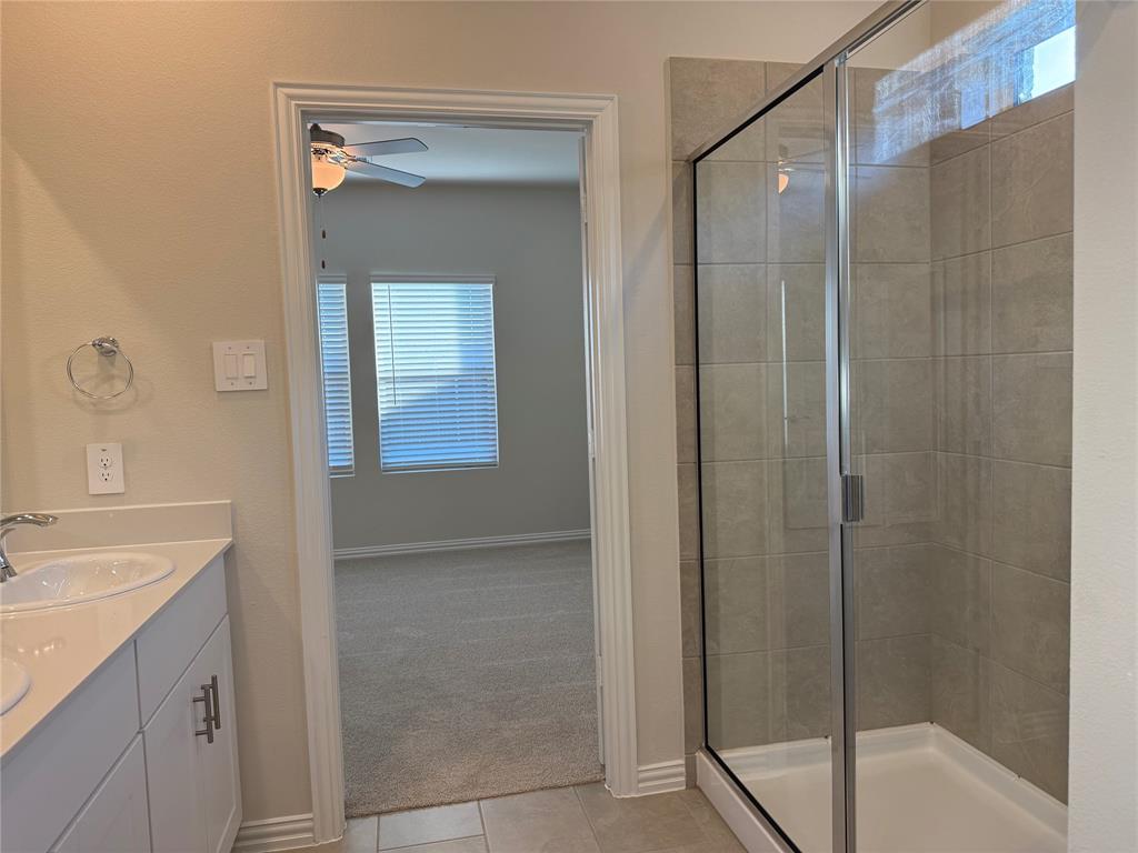 1736 Arches Road Anna, TX 75409 - Photo 8 of 18 Full bathroom featuring healthy amount of natural light, a shower stall, double vanity, and ceiling fan