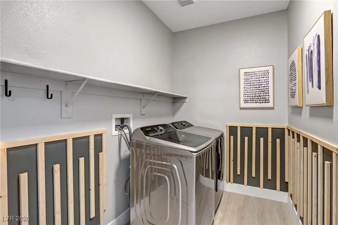 2835 Strathallan Avenue Henderson, NV 89044 - Photo 17 of 64 Washroom with wood finished floors and separate washer and dryer