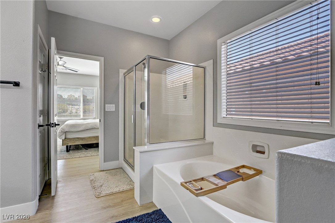 2835 Strathallan Avenue Henderson, NV 89044 - Photo 22 of 64 Bathroom featuring ensuite bathroom, a stall shower, a garden tub, and light wood-type flooring