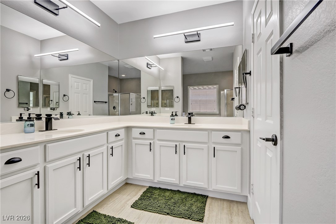 2835 Strathallan Avenue Henderson, NV 89044 - Photo 23 of 64 Full bathroom featuring double vanity, a stall shower, and light wood-style floors