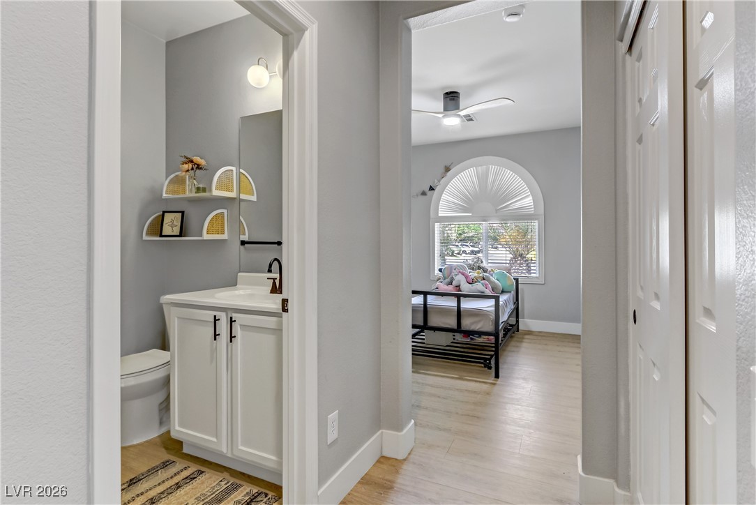 2835 Strathallan Avenue Henderson, NV 89044 - Photo 25 of 64 Half bath featuring vanity, light wood-style flooring, and ceiling fan