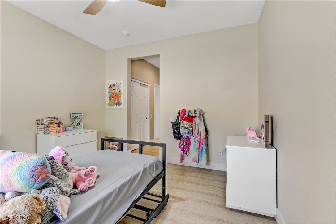 2835 Strathallan Avenue Henderson, NV 89044 - Photo 29 of 64 Bedroom featuring light wood-style flooring, ceiling fan, and a closet
