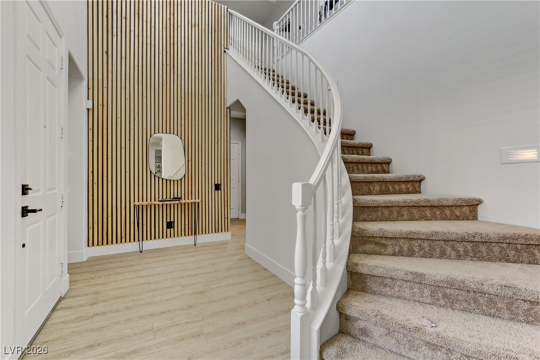 2835 Strathallan Avenue Henderson, NV 89044 - Photo 3 of 64 Staircase with wood finished floors and a towering ceiling