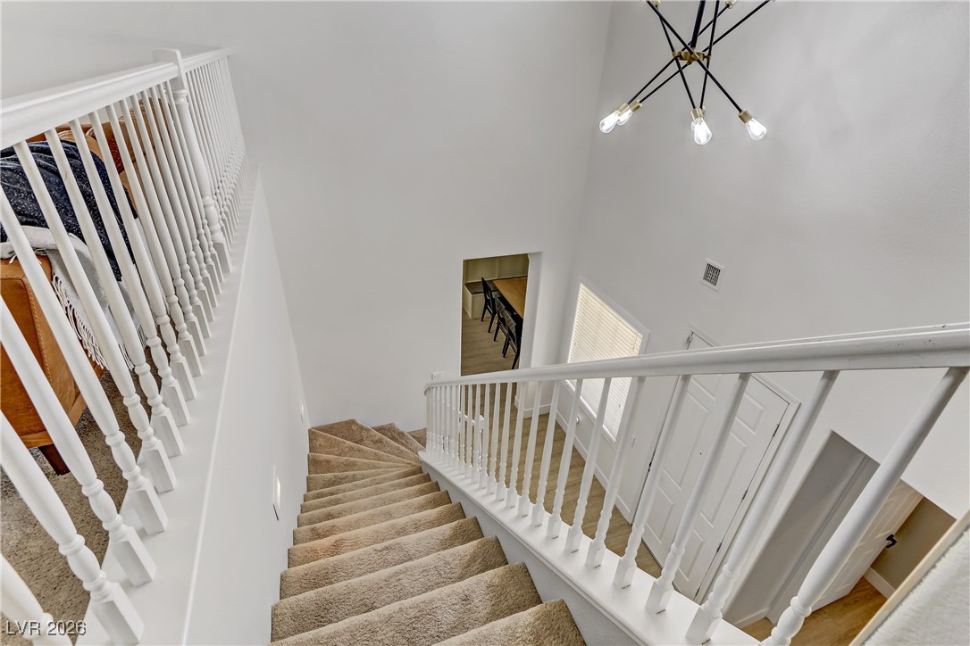 2835 Strathallan Avenue Henderson, NV 89044 - Photo 30 of 64 Staircase featuring a high ceiling and a chandelier