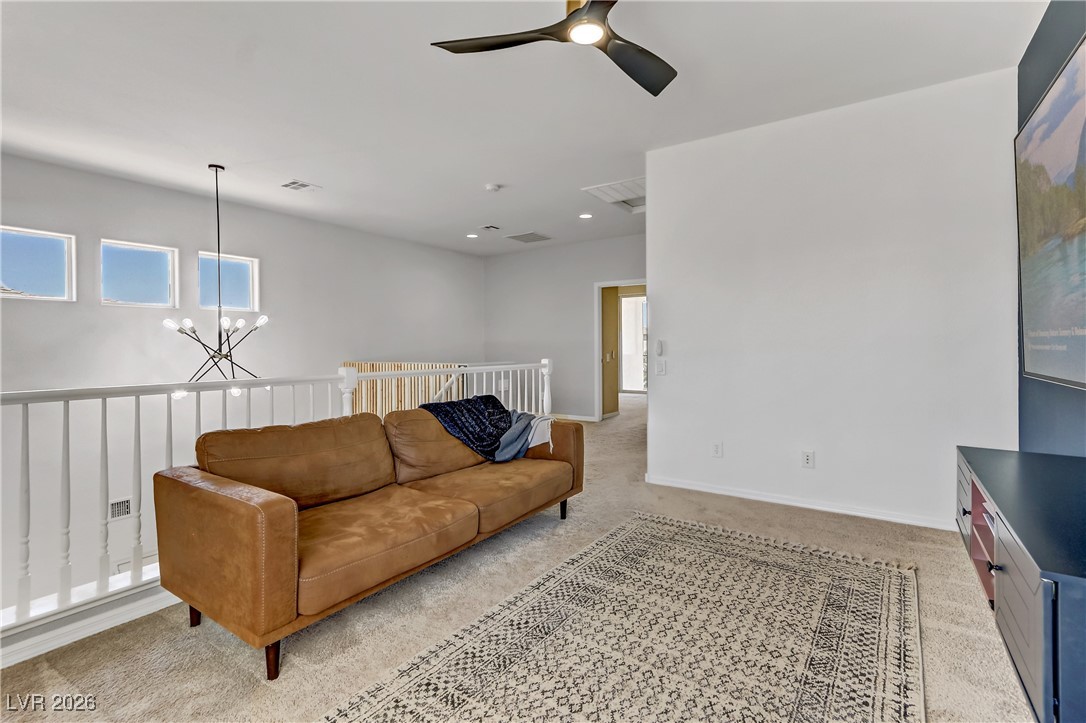 2835 Strathallan Avenue Henderson, NV 89044 - Photo 37 of 64 Living room featuring a chandelier, light colored carpet, and ceiling fan