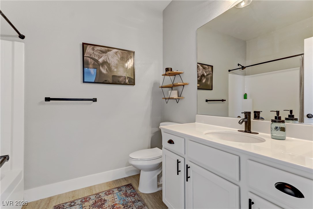 2835 Strathallan Avenue Henderson, NV 89044 - Photo 38 of 64 Bathroom with vanity, shower / bathtub combination, and light wood-type flooring