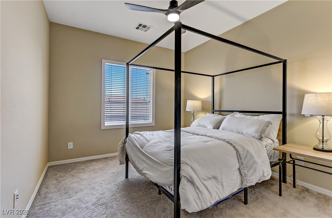 2835 Strathallan Avenue Henderson, NV 89044 - Photo 39 of 64 Bedroom with light colored carpet and ceiling fan