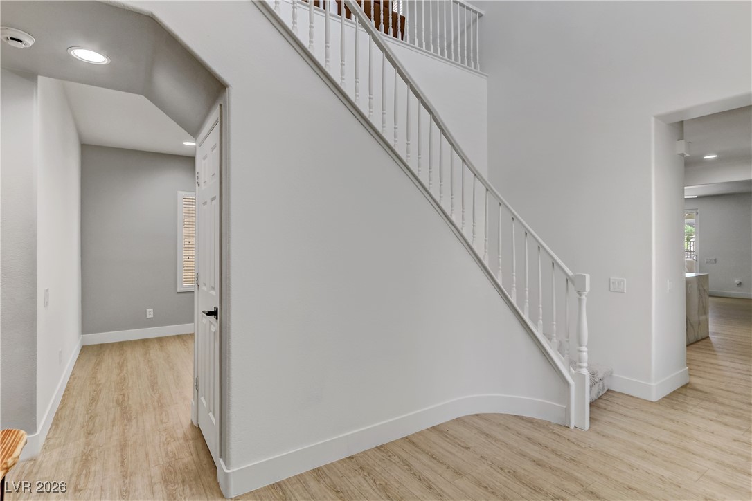 2835 Strathallan Avenue Henderson, NV 89044 - Photo 4 of 64 Stairs with recessed lighting, wood finished floors, and a towering ceiling
