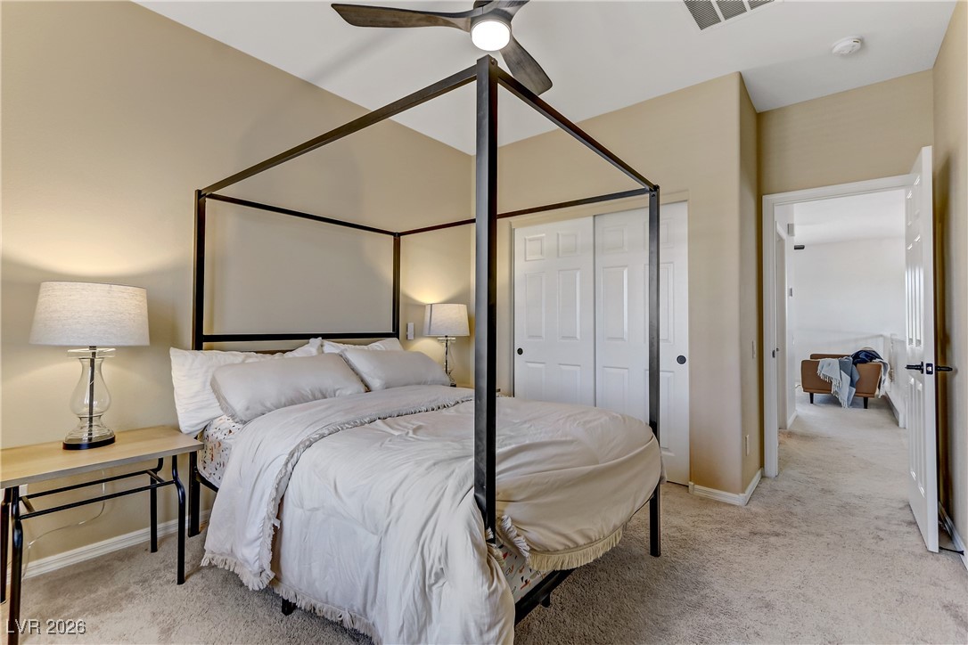 2835 Strathallan Avenue Henderson, NV 89044 - Photo 40 of 64 Bedroom featuring light colored carpet, ceiling fan, and a closet