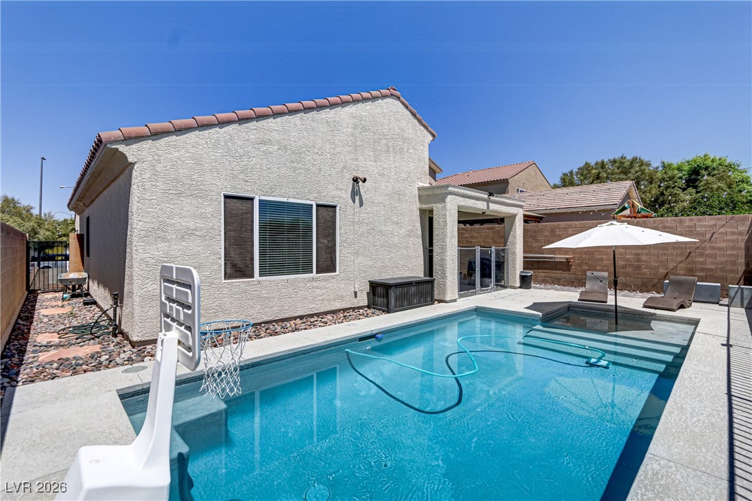 2835 Strathallan Avenue Henderson, NV 89044 - Photo 46 of 64 View of swimming pool featuring a fenced backyard, a patio area, and a pool with connected hot tub