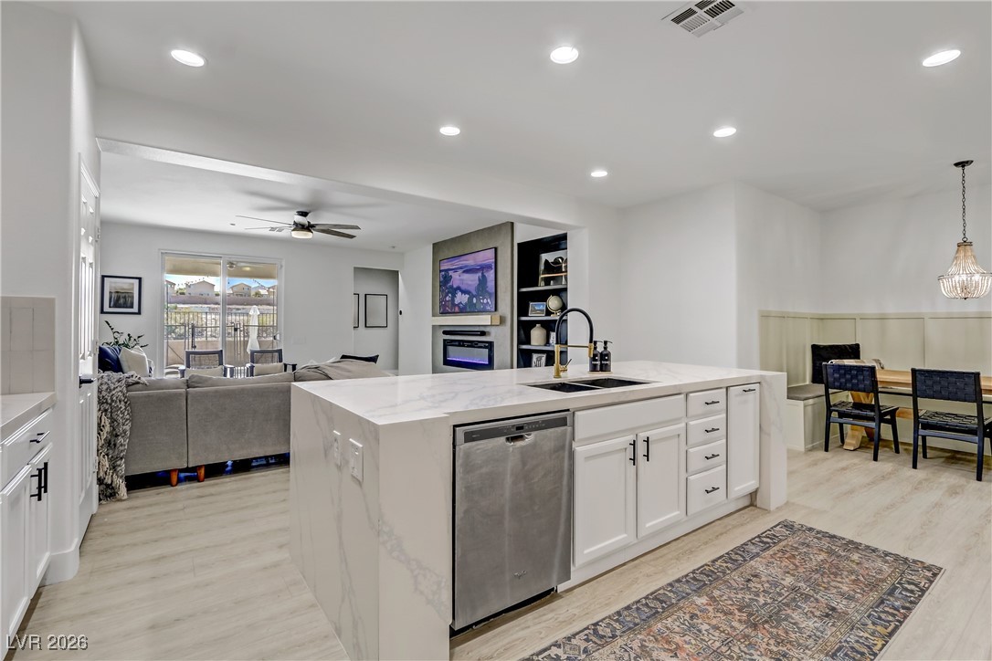 2835 Strathallan Avenue Henderson, NV 89044 - Photo 64 of 64 Kitchen with open floor plan, white cabinetry, stainless steel dishwasher, an island with sink, and recessed lighting