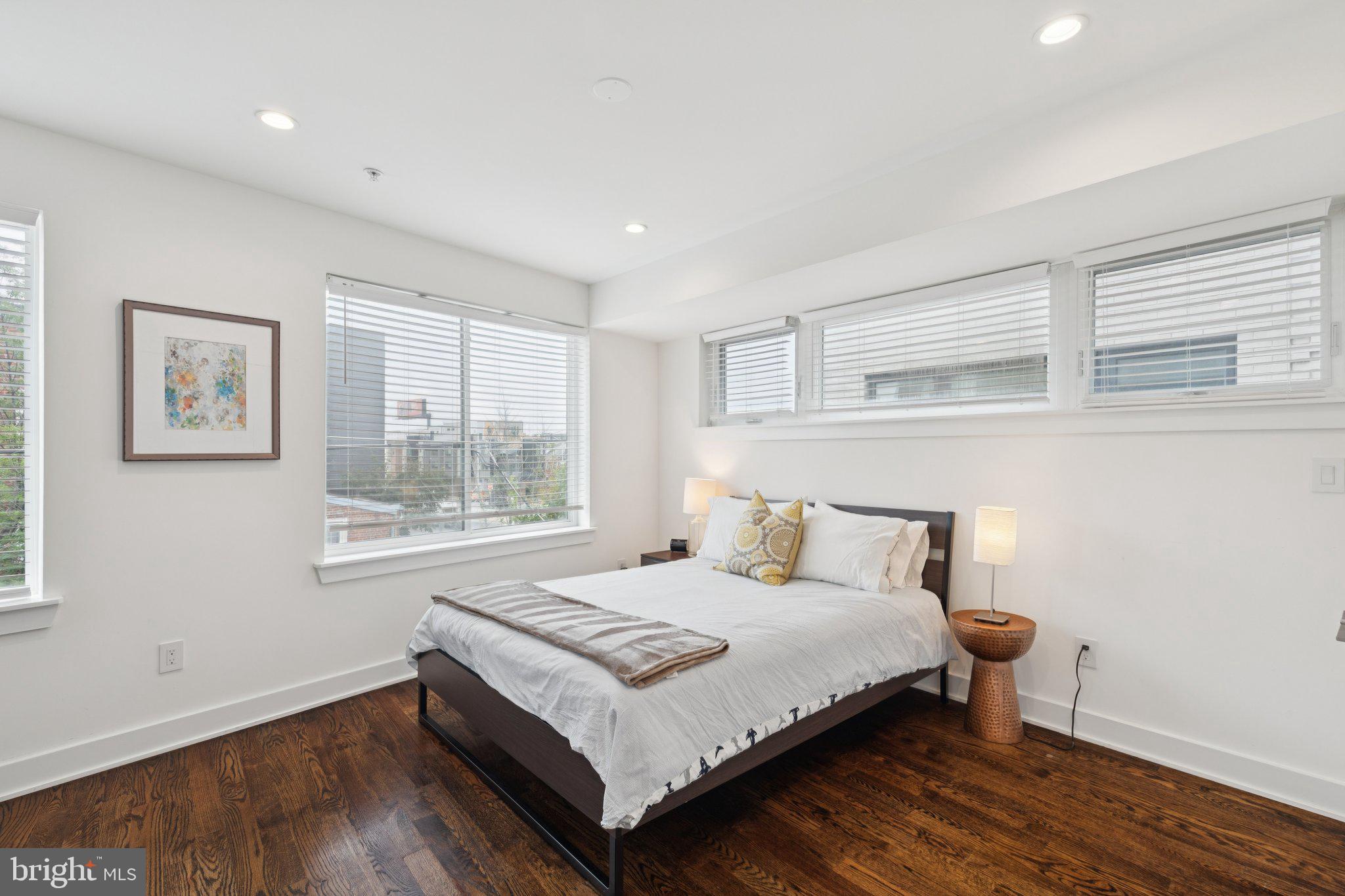 1022 South 2nd Street, Unit 2 Philadelphia, PA 19147 - Photo 16 of 46 a bedroom with a bed lamp and window