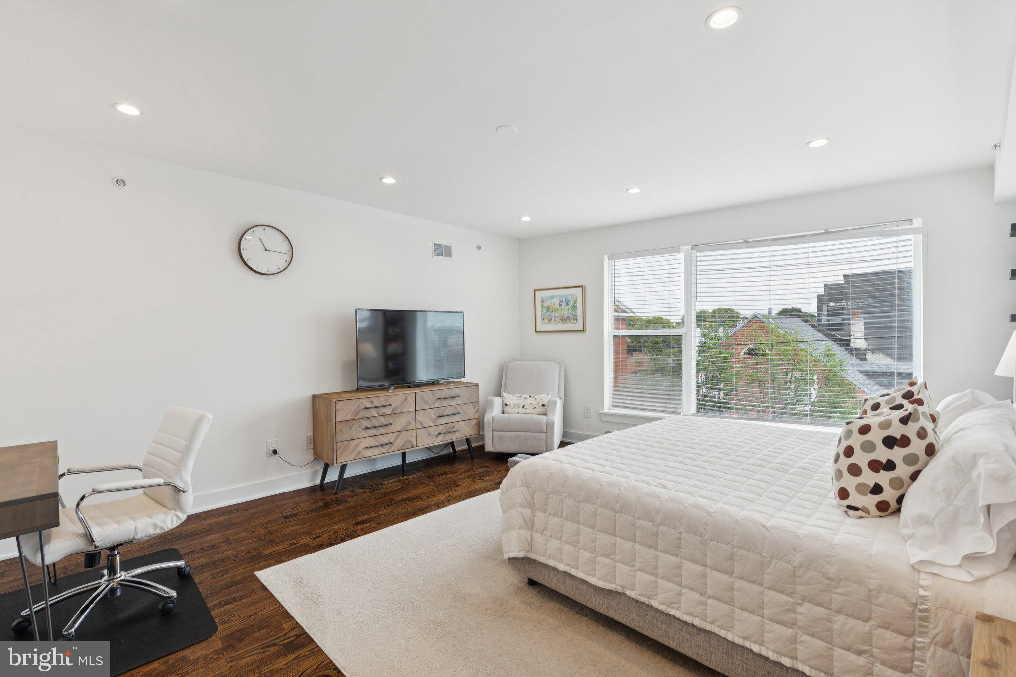 1022 South 2nd Street, Unit 2 Philadelphia, PA 19147 - Photo 28 of 46 a bedroom with a bed and wooden floor