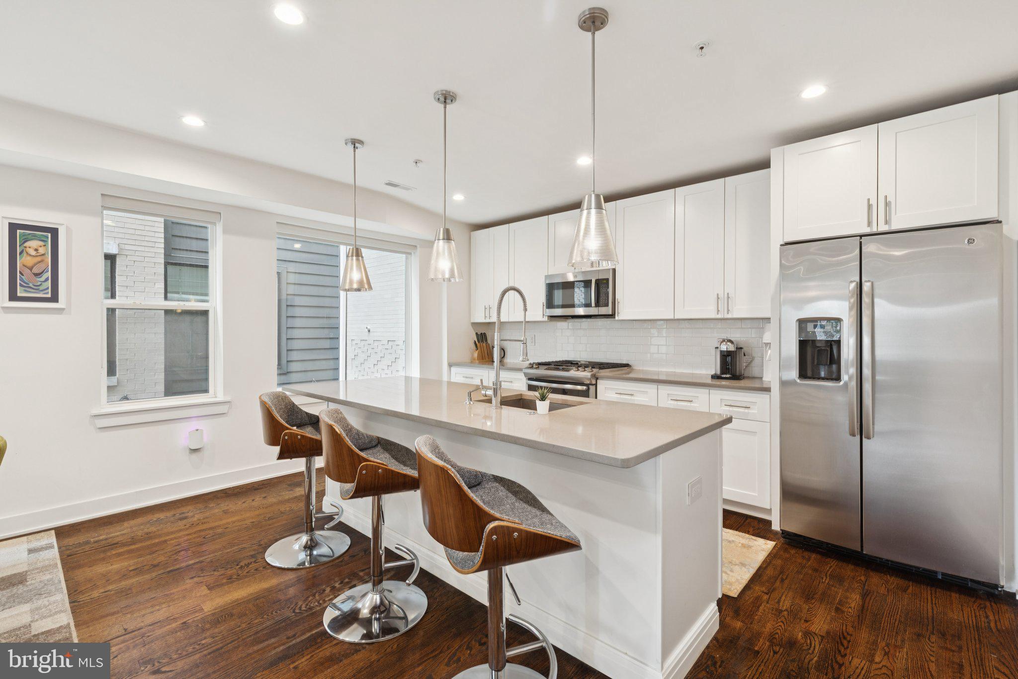 1022 South 2nd Street, Unit 2 Philadelphia, PA 19147 - Photo 3 of 46 a kitchen with stainless steel appliances a dining table chairs and wooden floor