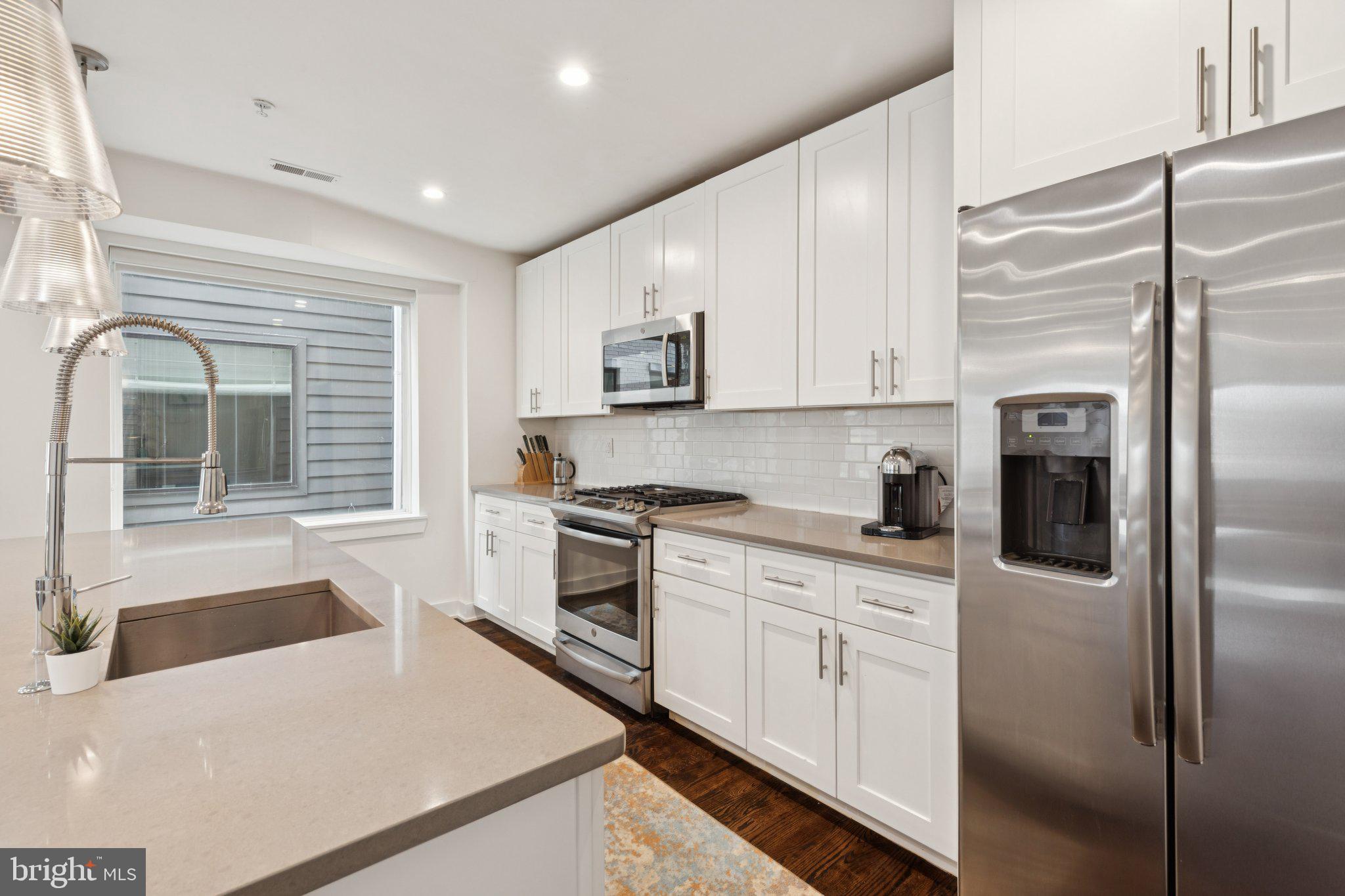 1022 South 2nd Street, Unit 2 Philadelphia, PA 19147 - Photo 4 of 46 a kitchen with white cabinets and white appliances