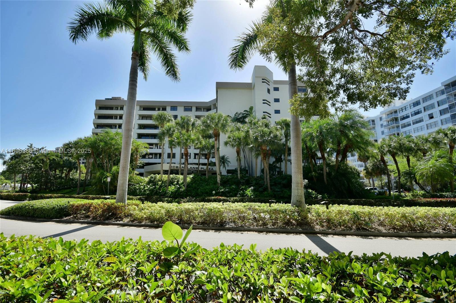 170 Ocean Ln Drive, Unit 311 Key Biscayne, FL 33149 - Photo 1 of 32 a view of a garden with a building in the background