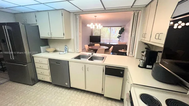 a kitchen with a sink appliances and cabinets