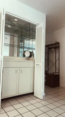 a view of a bathroom with a sink and a mirror