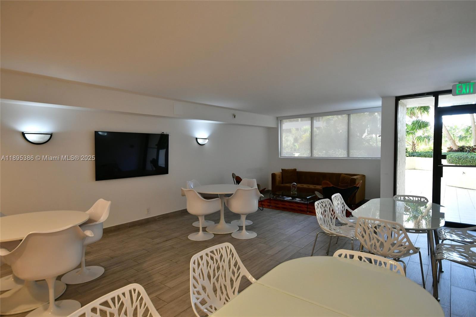 170 Ocean Ln Drive, Unit 311 Key Biscayne, FL 33149 - Photo 24 of 32 a living room with furniture a flat screen tv and a large window