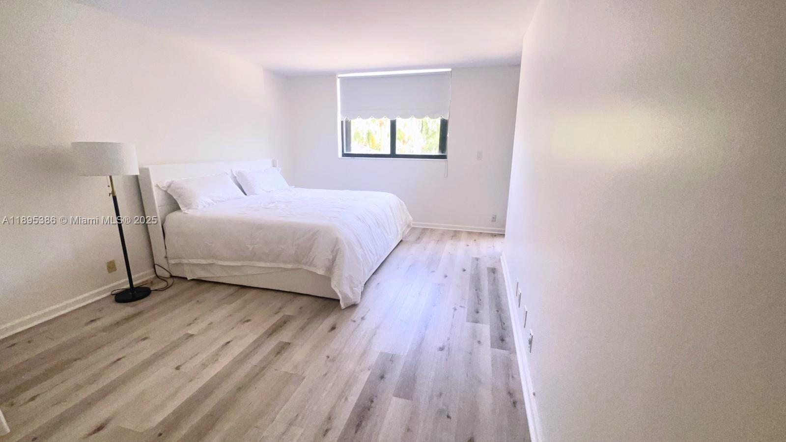 170 Ocean Ln Drive, Unit 311 Key Biscayne, FL 33149 - Photo 3 of 32 a bedroom with a bed and a window